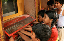 Children use Sugata Mitra’s hole-in-the-wall computer in a slum in New Delhi. Credit: TED/Sugata Mitra.