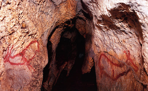 Cave entrance with rock art.