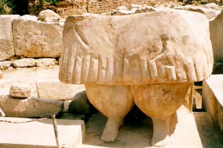 The feet and skirt of a female statue seen in the South Temple
