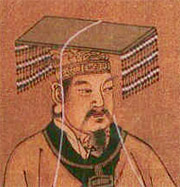 man with a square hat with beads