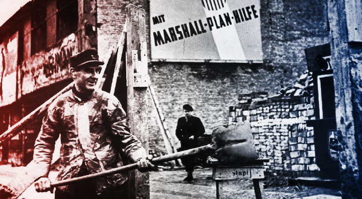 Man with shovel with Marshall Plan poster in Germany