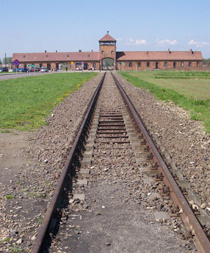 Railroad track leading to a brick building
