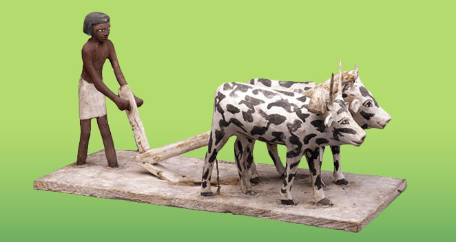 Wooden statue of a man and 2 oxen