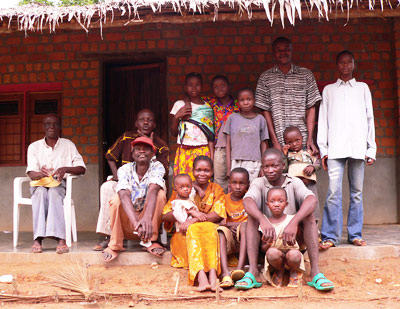 A family portrait in front of a house in Africa
