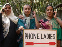 Women with cell phones and a sign that says Phone Ladies