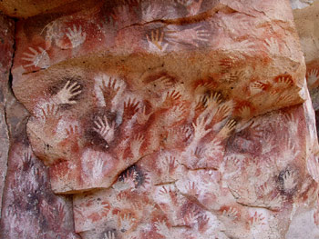 many stenciled hands on a cave wall