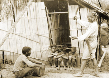 shaman standing in front of 3 children