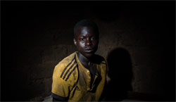 African boy against a dark background