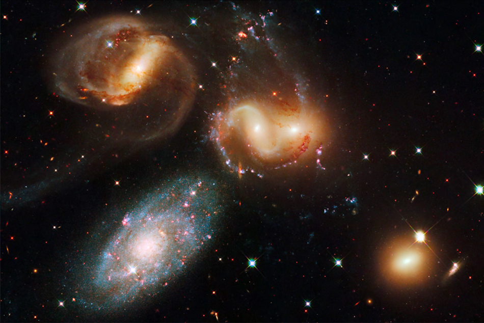 A photo of galaxies in the night sky taken by the Hubble Space Telescope.