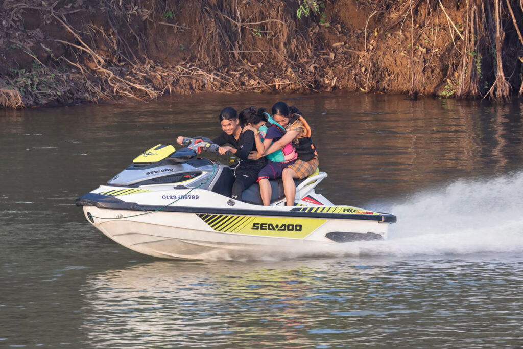 Three teenagers on a jetski running at full speed on the Mekong. Basile Morin, Wikimedia Commons