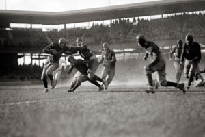 A photo of a mid-20th century American football match,.