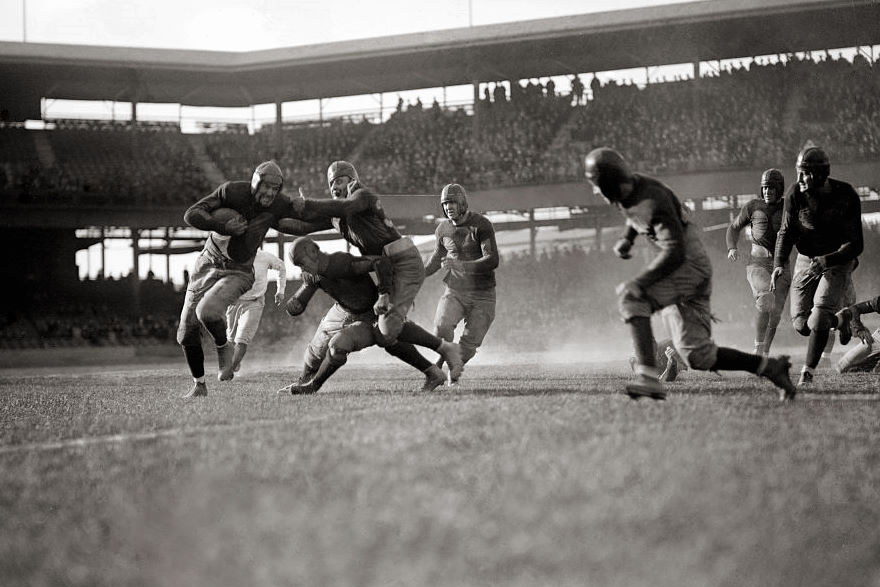 A photo of a mid-20th century American football match,.