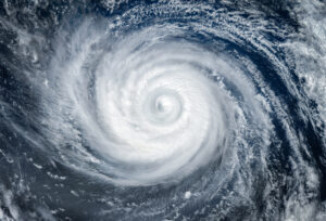 A photograph taken from space of a tropical cyclone or hurricane over the ocean.