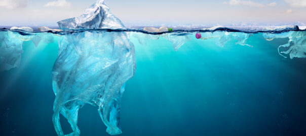 An illustration showing plastic bags and bottles floating on the surface of the ocean.