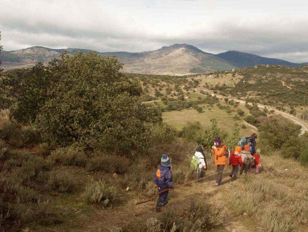 Children outdoors attending the Saltamontes forest school in Spain.