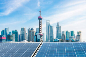 The skyline of Shanghai China, with solar energy panels in the foreground.