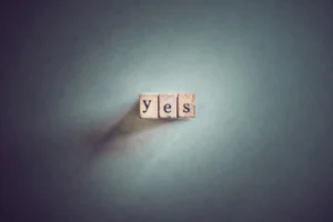 Three alphabet cubes forming the word YES.